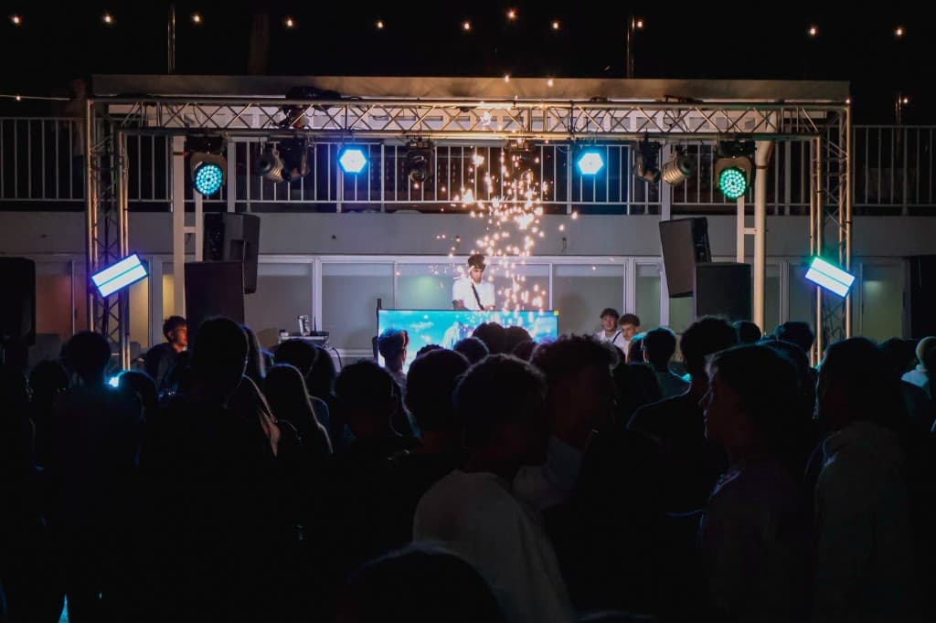 Main stage with sparks and blue lighting over the crowd